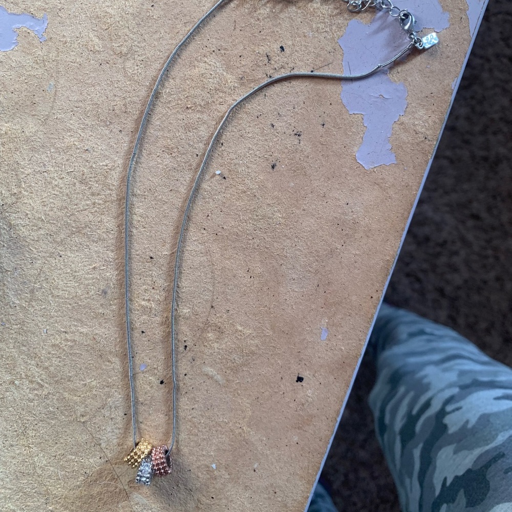 Silver necklace with rose gold, silver, and gold beads for $5
